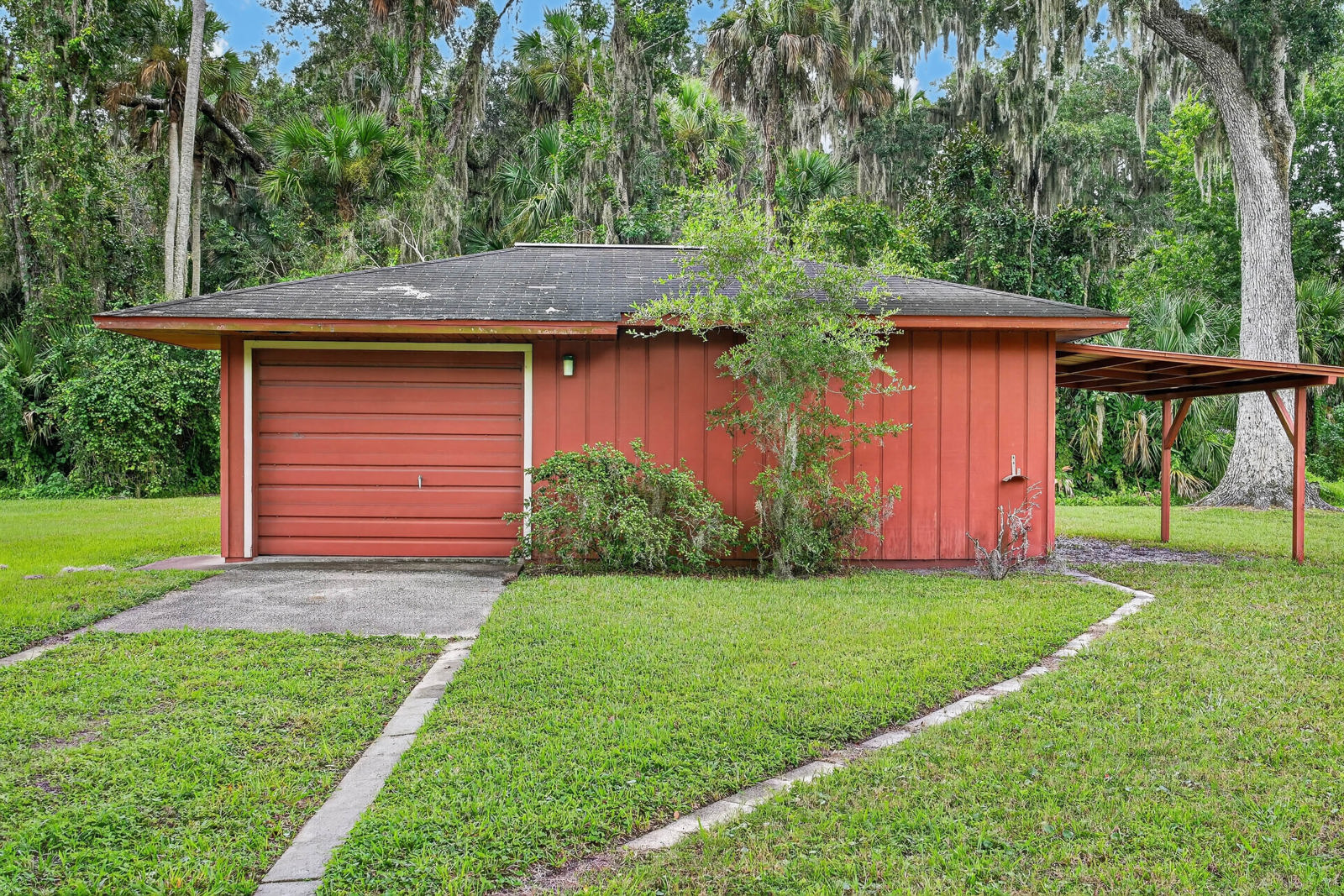 Detached garage with open side carport