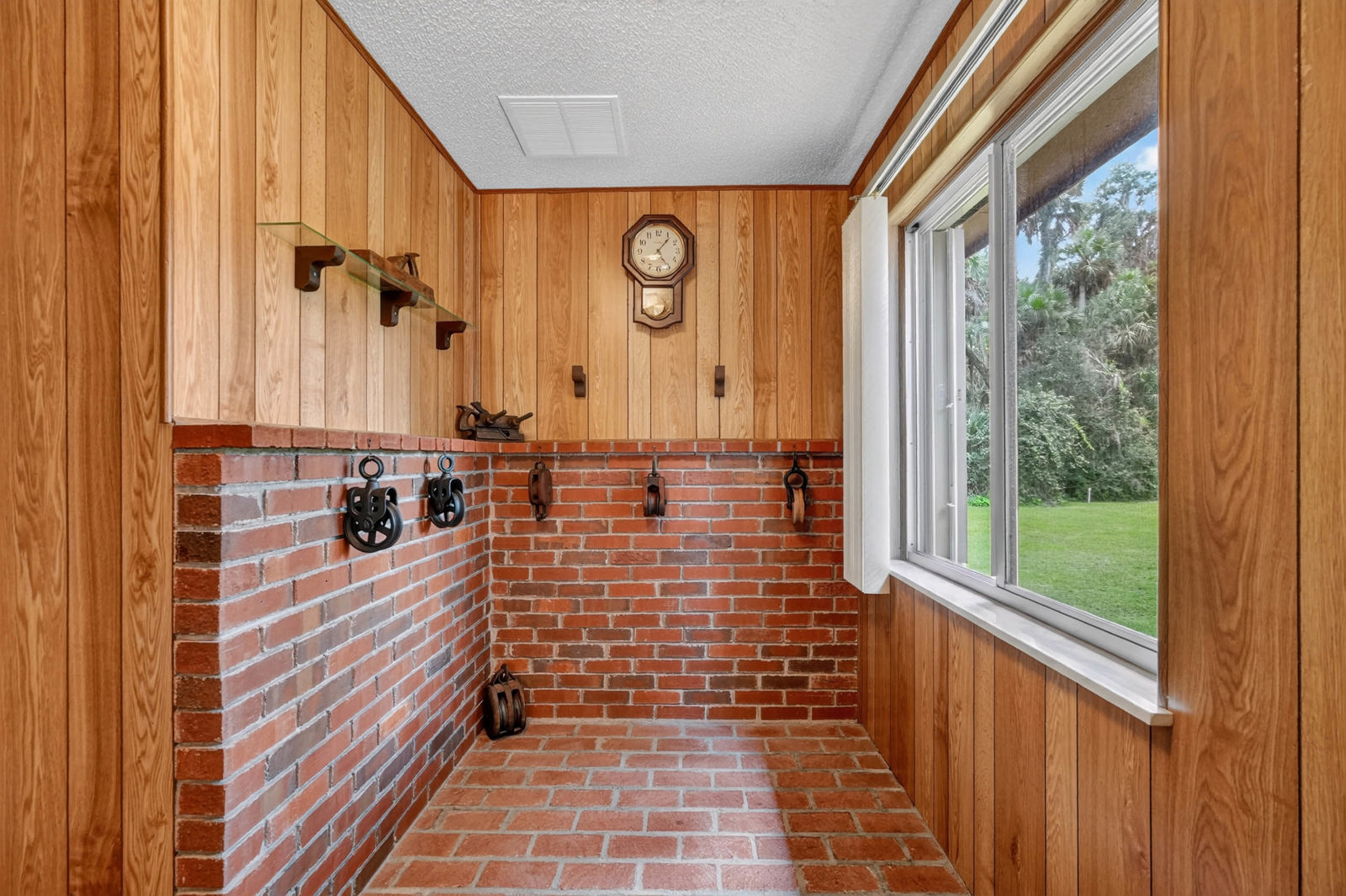 Wood-and-brick interior room with backyard view